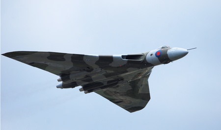 Vulcan Bomber flying from left to right on blue sky backgroundのeditorial素材