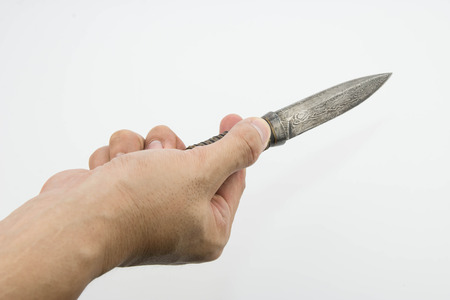 A hand holding a Thai knife isolated on white backgroundの写真素材