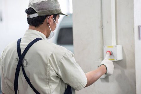 A Technical man Push the Emergency Buttonの写真素材