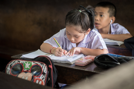 BANGKOK THAILAND - August 23, 2017 : The student girl is studying very concentrate. She do homework in the classroom at Wannawit School Thailand.のeditorial素材