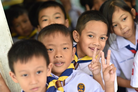 BANGKOK THAILAND - August 23, 2017 : Group of Kindergarten Children or young students be happy smile and hold two fingers after class at Wannawit School Thailand.のeditorial素材