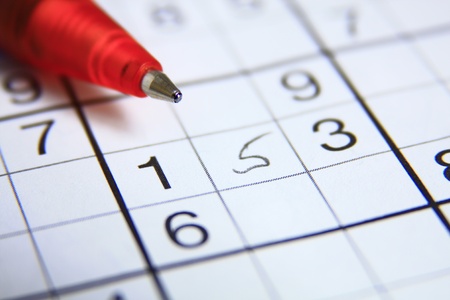 red ball-point pen on a sudoku-riddleの写真素材