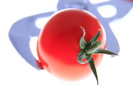 cocktail tomatoes in the jaws of a water pump pliersの写真素材
