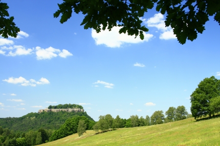 Landscape in Saxony with meadow, woods and blue skies and views of the fortress Königsteinの写真素材