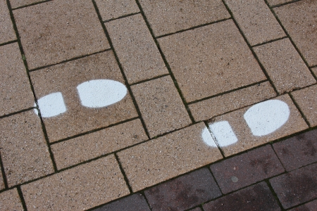 painted footprints on the pavement as a guideの写真素材