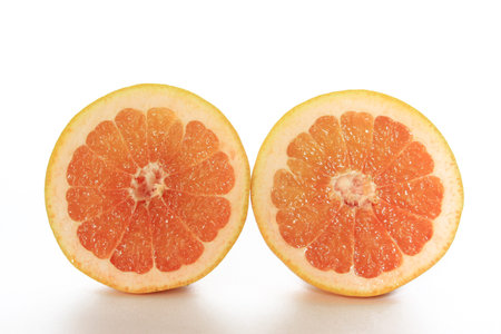Halved Grapefruit isolated on white background  Citrus x aurantium  Citrus paradisi 