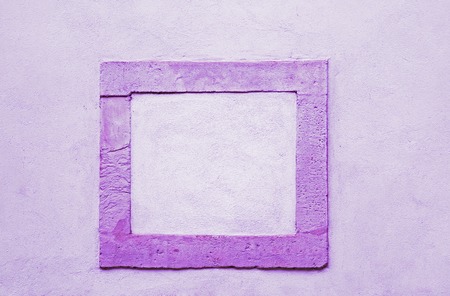 Dark purple frame of stone in a bright wallの写真素材