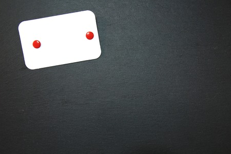 Blackboard (slate) with blank, writable notepadの写真素材