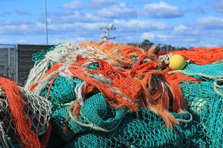 Fishing nets in the port of Loctudy, Finistere, Brittany, France spread to dryの写真素材