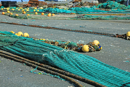 Fishing nets in the port of Loctudy, Finistere, Brittany, France spread to dryの写真素材