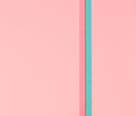 Blue and pink zipper on a pink background. Flat lay conception in minimal style.の写真素材