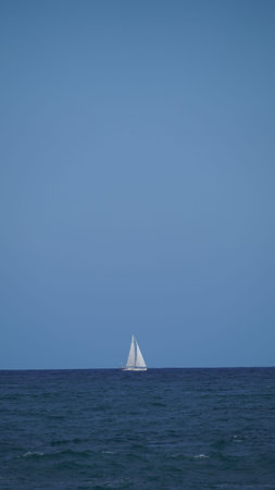 Sailboat on the horizon sailing the Pacific Ocean near by Galapagos Islandsの写真素材