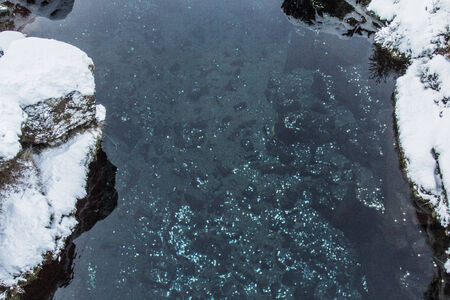Close up photo of the coins in the Coin Fissure in Thingvellir National Park, Iceland.の写真素材