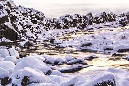 Sunset at Oxararfoss Waterfall in ?ingvellir National Park Iceland.This photo captures the water at the bottom of the waterfall and was taken on our travels to Iceland in December 2014の写真素材