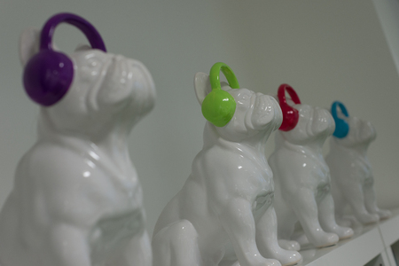 Line of ceramic pugs with headphones on.の写真素材