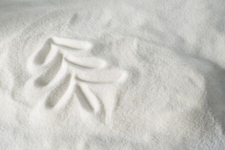 Christmas tree shape drawn in snowの写真素材