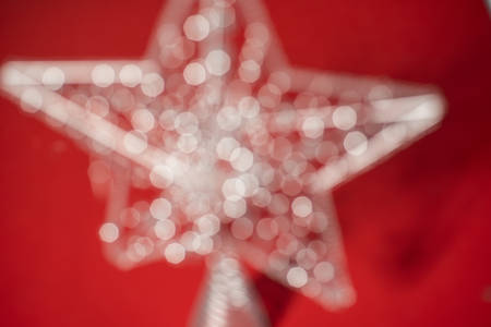 Silver star close up on a red backgroundの写真素材