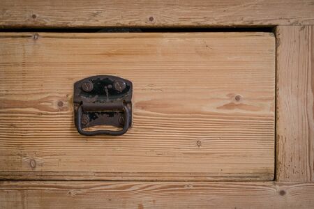 brown wooden drawer with cast iron handleの写真素材