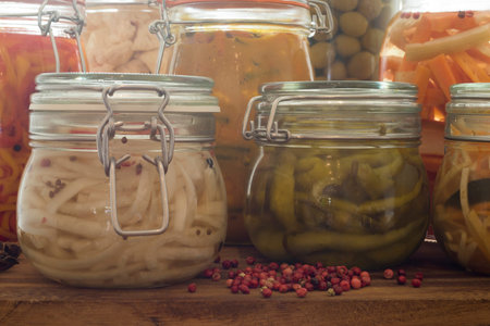 A close up selection of pickled and fermented vegetables in Kilner jarsの写真素材