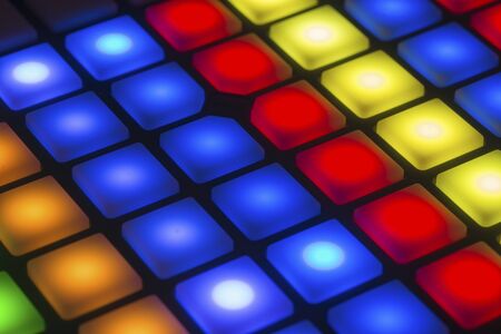 Abstract display of lit control buttons on a stage lighting control panelの写真素材
