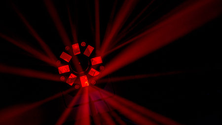 Bright coloured red disco light shot in darkened club