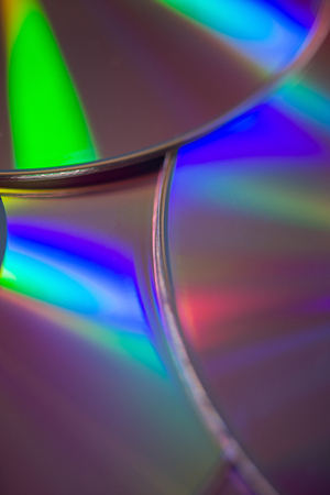 Close up of edges of compact discs or DVDs for abstract or backgrounds.の写真素材