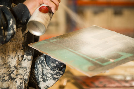 A small wooden board painted white using aerosol spray.