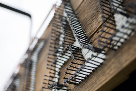 Closeup of a wooden signage with black screws drilled to form letters