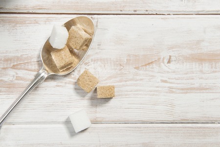 SUGAR CUBES IN CEREAL SPOON TO DEMONSTRATE THE AMOUNT OF SUGAR IN CHILDREN'S BREAKFAST CEREALの写真素材