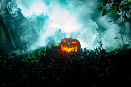 Glowing scary pumpkin head in dim hazy sceneryの写真素材