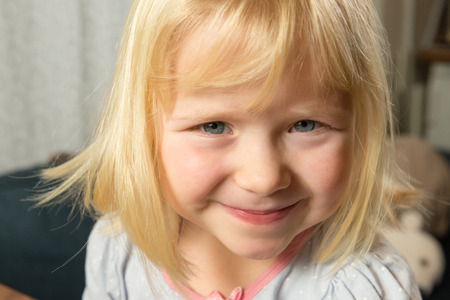 Close up of happy smiling five year old blonde girlの写真素材