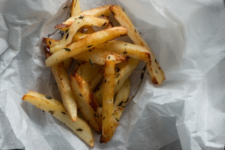 Baked seasoned ships on paper with copy spaceの写真素材