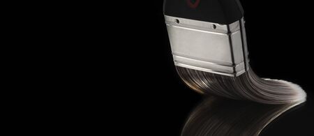 Paintbrush bristles bent against a smooth reflective surfaceの写真素材