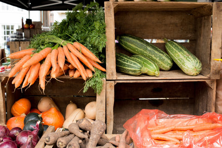 Fresh vegetables sorted in crates at an outdoor market