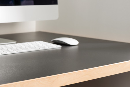 Office workstation with a view of a desktop computer, keyboard, and a mouse.の写真素材