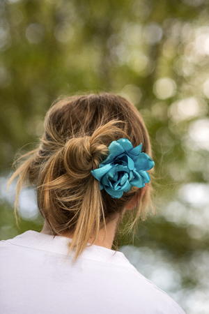 Blue flower hair clip on a woman's headの写真素材
