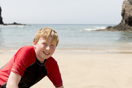Portrait of a young boy with beach in the backgroundの写真素材