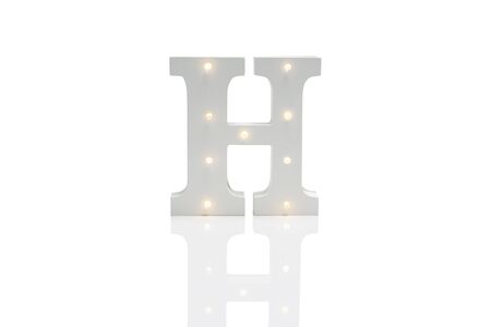 A decorative letter H with illuminated embedded LED lights over a white backgroundの写真素材