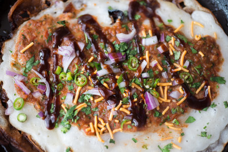 Overhead closeup of a traditional Indian dosa on a hot round griddle