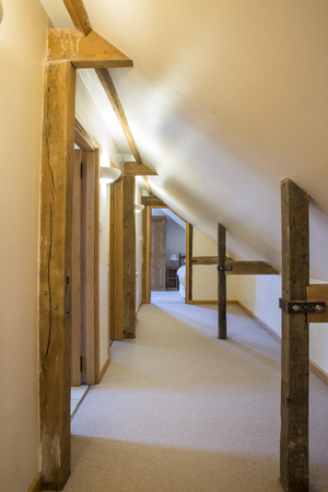 Attic hallway of a vacation cottage with wooden bracesの写真素材