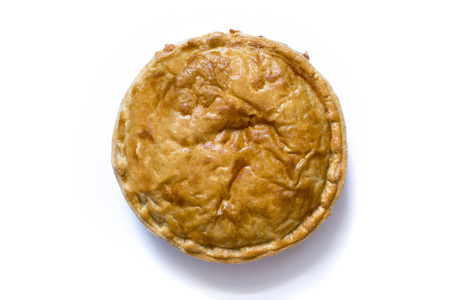 Overhead shot of a cooked whole meat pie over a white backgroundの写真素材