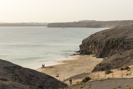 View of one of the Papagayo beaches looking across beach with the resort of Playa Blanca in the distance.のeditorial素材