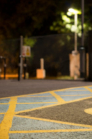 Defocused illuminated city street at night