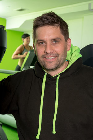 Guy in a black hoodie jacket in the gymのeditorial素材