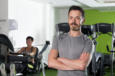 Man with arms crossed in a health clubのeditorial素材