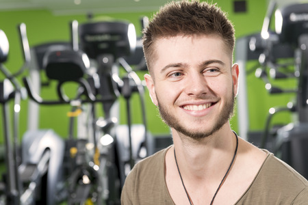 Smiling bearded young man in a gym looking awayのeditorial素材