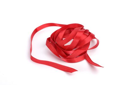 Red satin ribbon isolated on white backgroundの写真素材