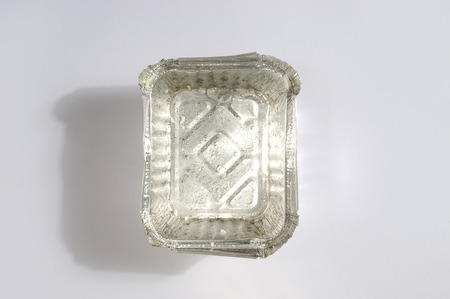 Overhead view of a clean aluminum foil tray on a white backgroundの写真素材