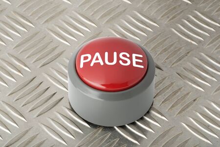 Red circular panic push button labeled 'Pause' on aluminum diamond plate backgroundの写真素材