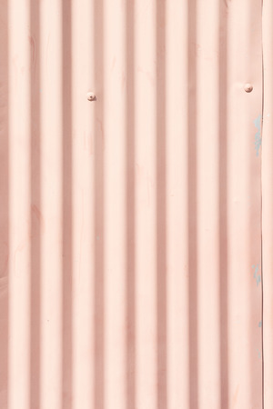 Pink corrugated iron sheet shot vertically for backgroundsの写真素材